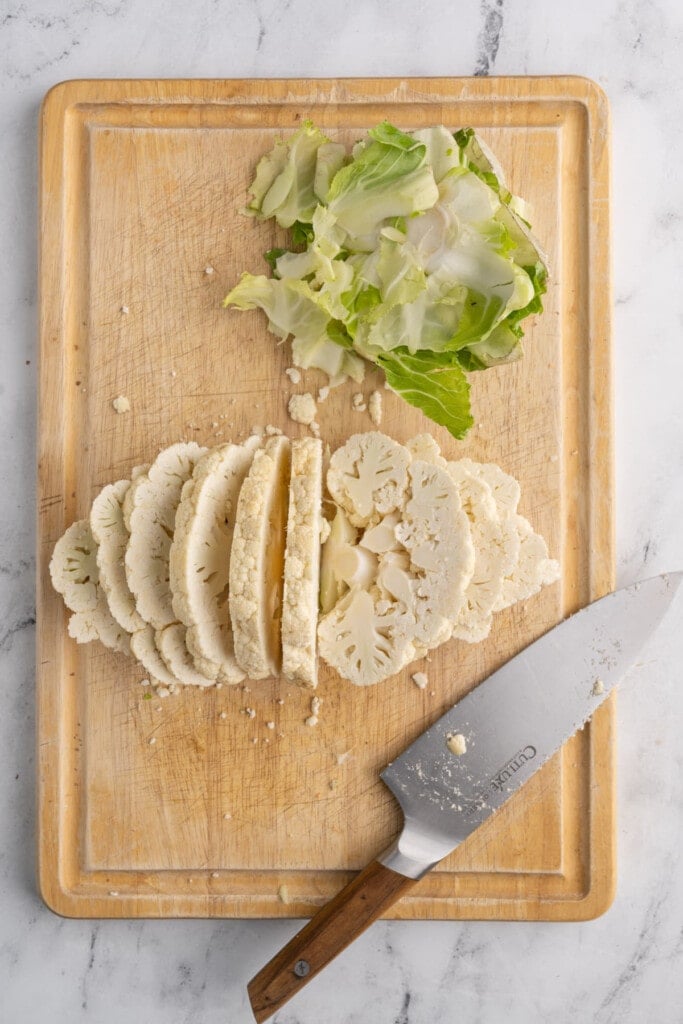 Slicing cauliflower into thin steaks.