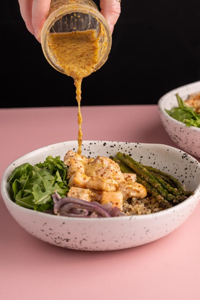 Adding honey dijon to dress salmon quinoa bowl