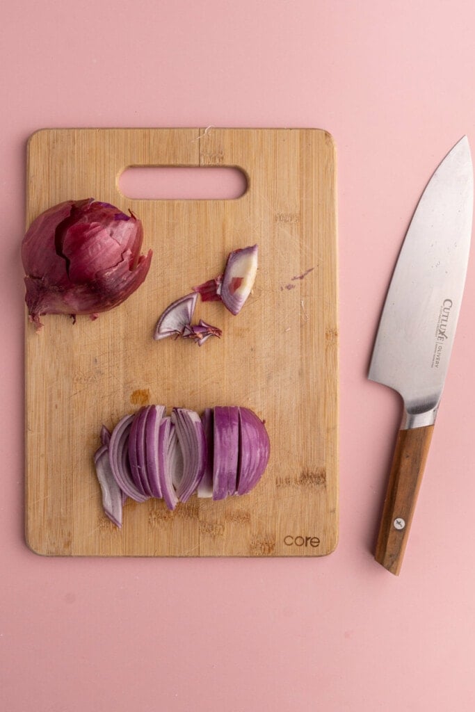 Slicing red onion into thin strips