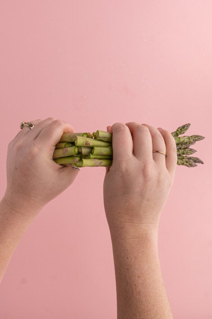 Snapping woody ends off of asparagus for quinoa bowl