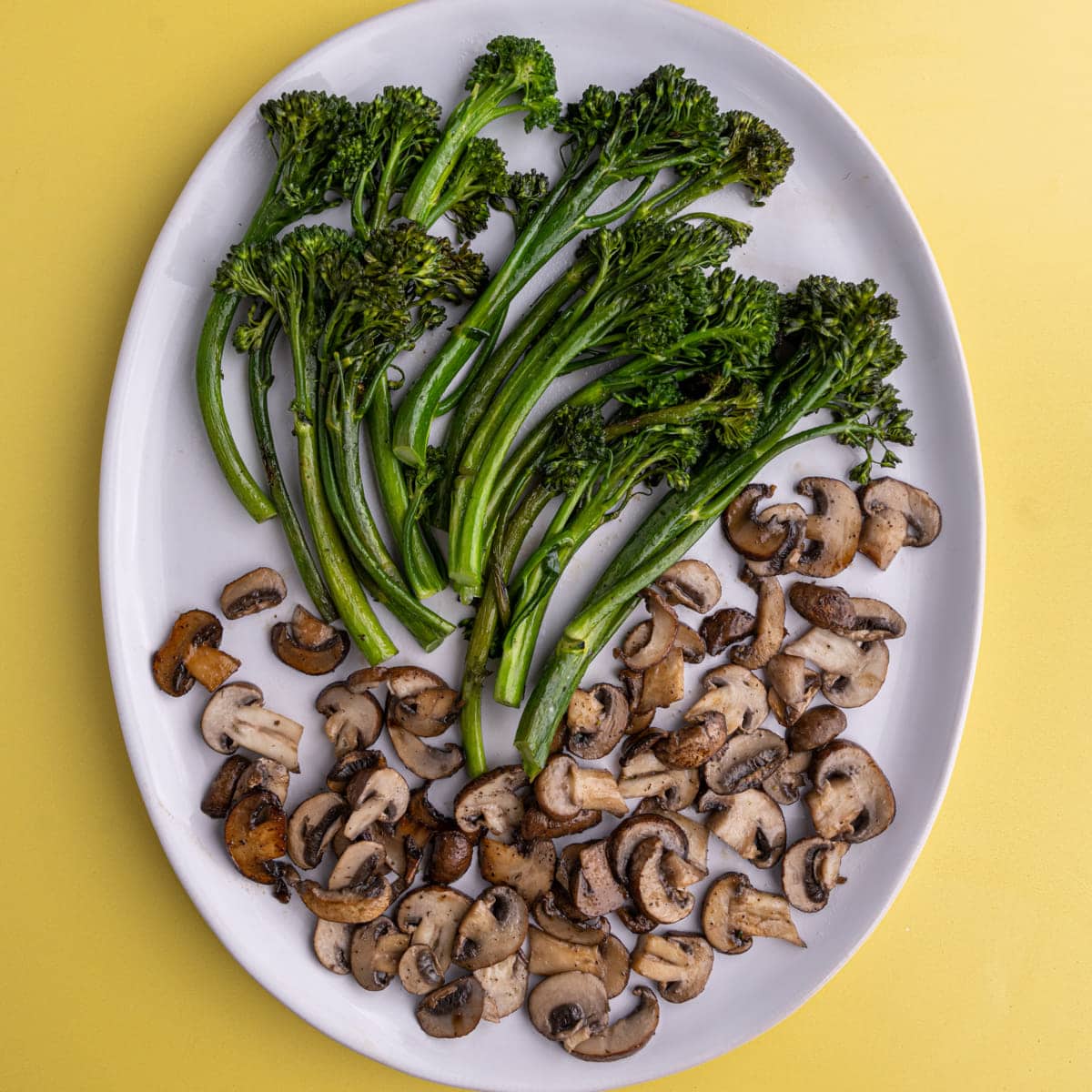 Sauteed Broccolini and Mushrooms on a white serving plate