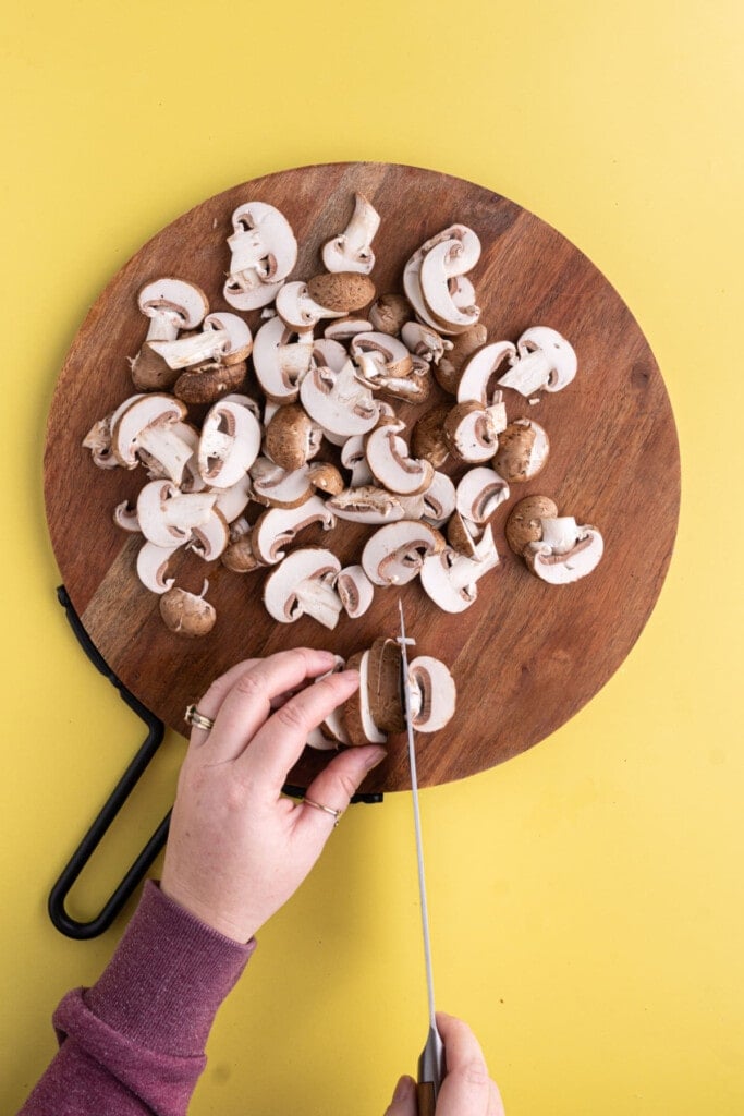 Slicing baby bella mushrooms