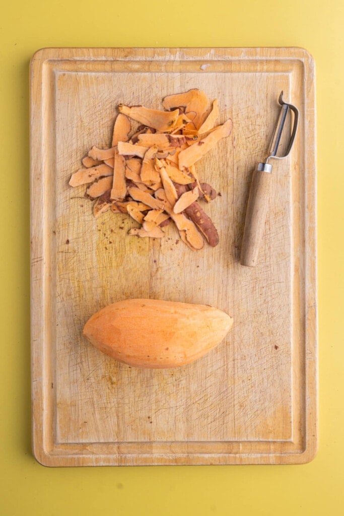 Peeling sweet potato to prep for roasting