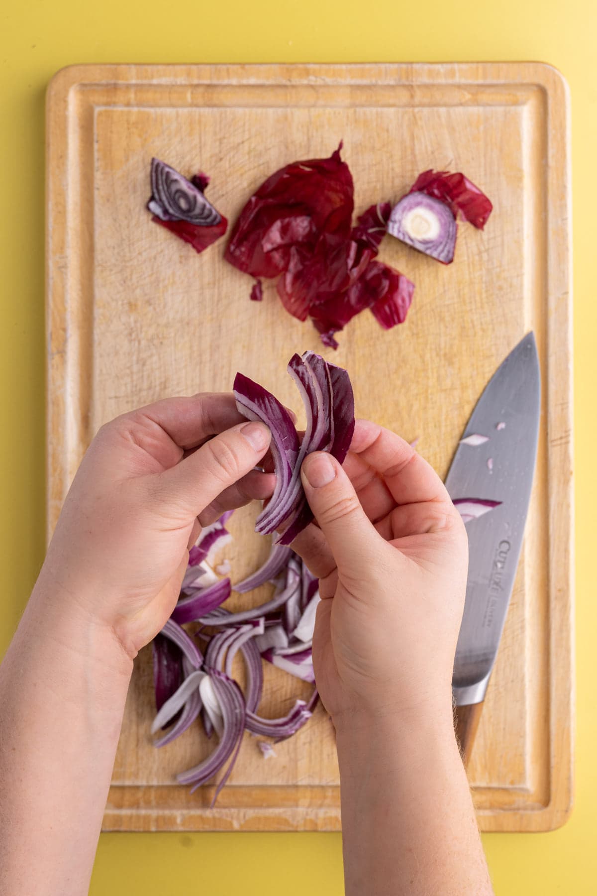 Separating layers of sliced red onion.