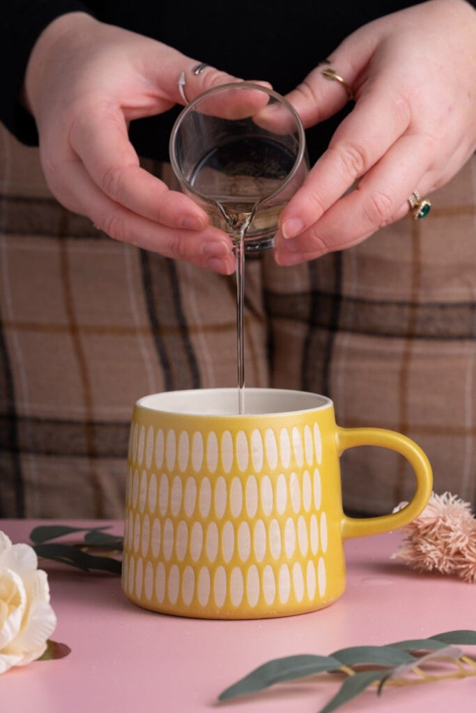 Adding oil to a mug to make a Vegan Vanilla Mug Cake