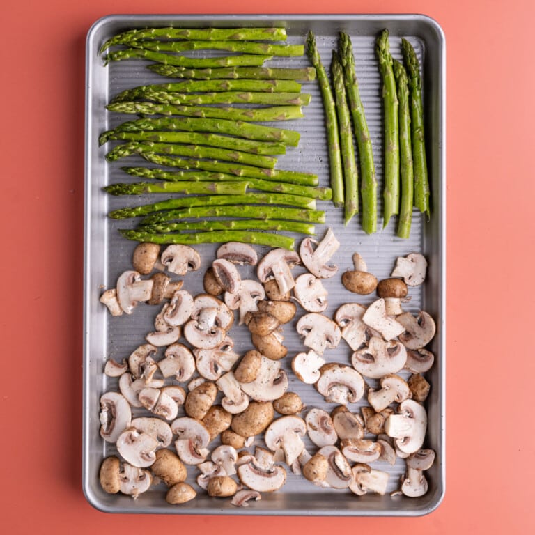 Prepped mushrooms and asparagus ready to be roasted in the oven