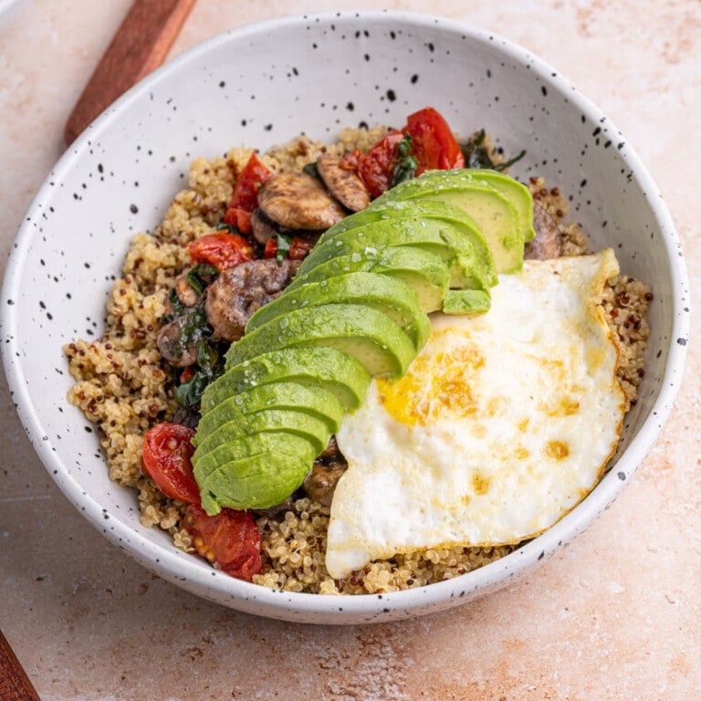 Savory quinoa breakfast bowl with egg on top