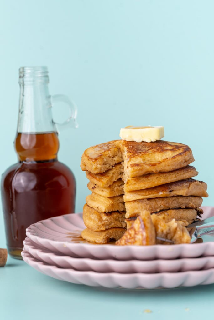Stack of pancakes with maple syrup with bite cut out