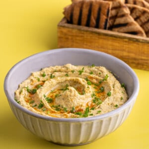 Bowl of Buffalo Ranch Hummus garnished with fresh parsley