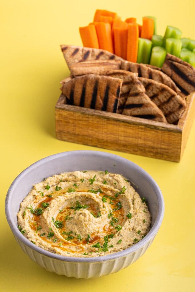 Buffalo Ranch Hummus with grilled pita, carrot sticks, and celery to serve