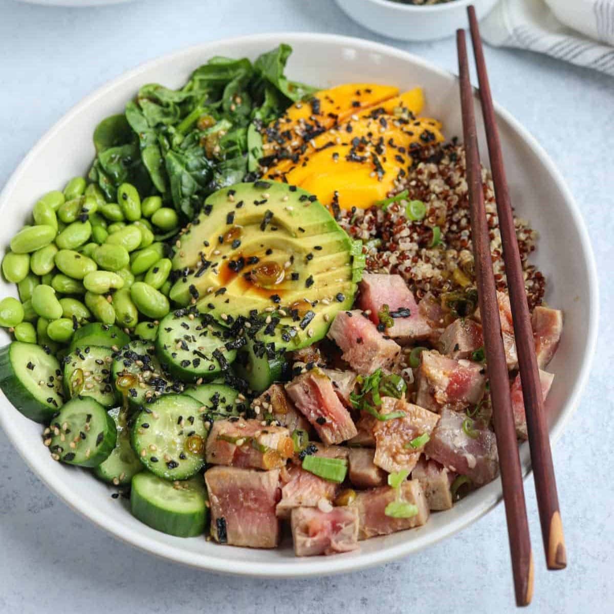 Homemade Quinoa Poke Bowl with a pair of chopsticks resting on the bowl