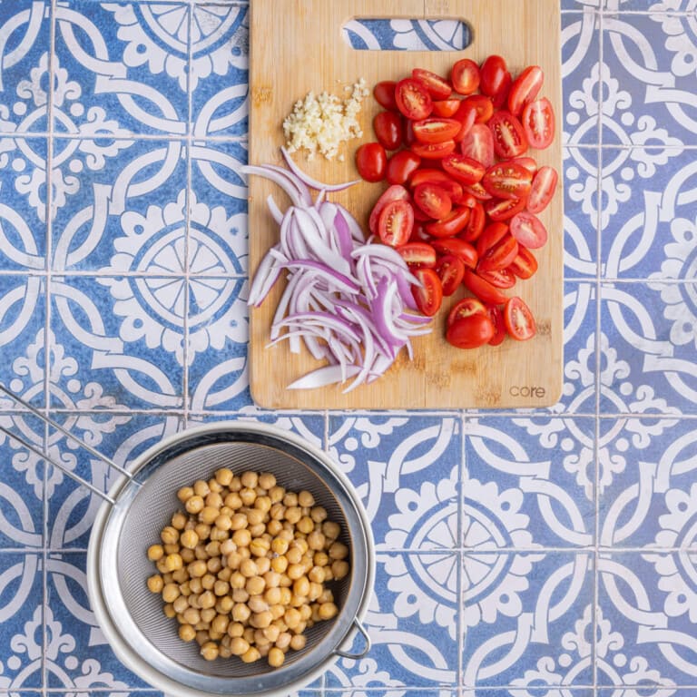 Prepped chickpeas, garlic, grape tomatoes, and red onion