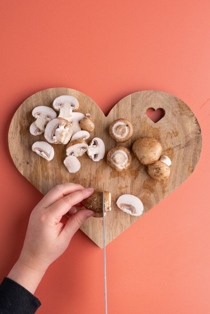 Slicing mushrooms into thin pieces