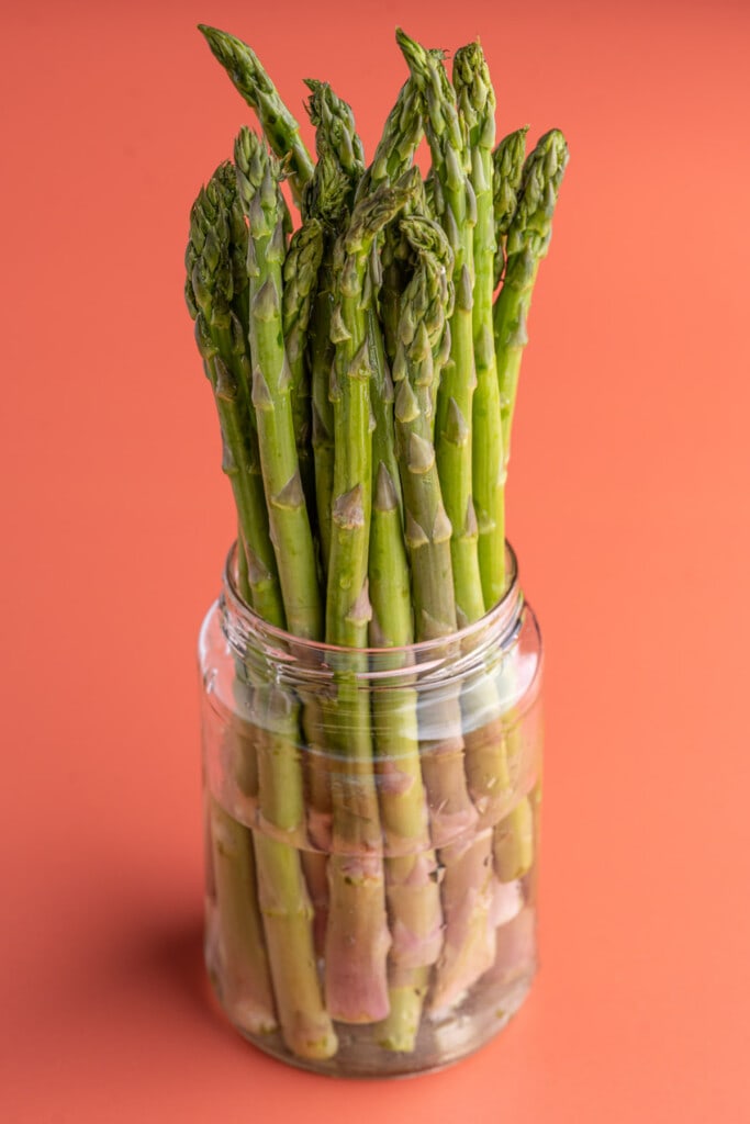 Storing asparagus with tips submerged in water
