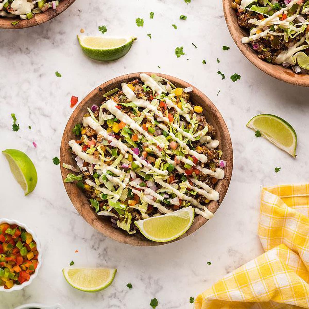 Slow Cooker Tex Mex Quinoa Taco Bowl on a table with lime wedges