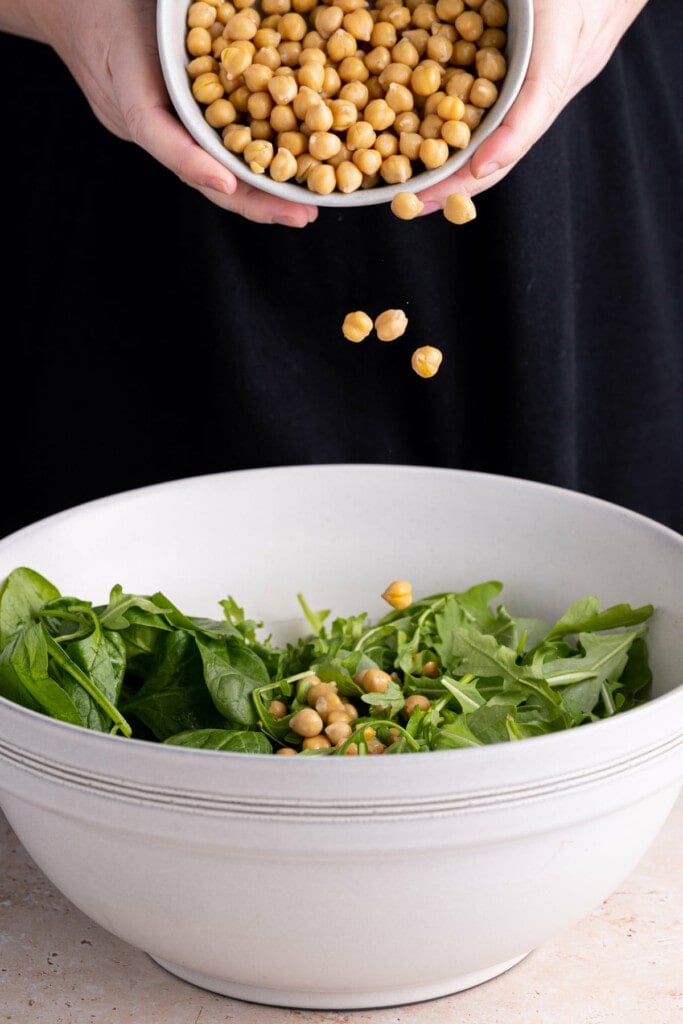 Adding chickpeas to Spinach Arugula Salad