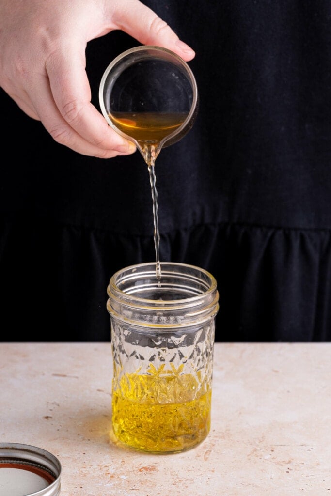 Mixing up Honey Dijon Vinaigrette in a glass jar