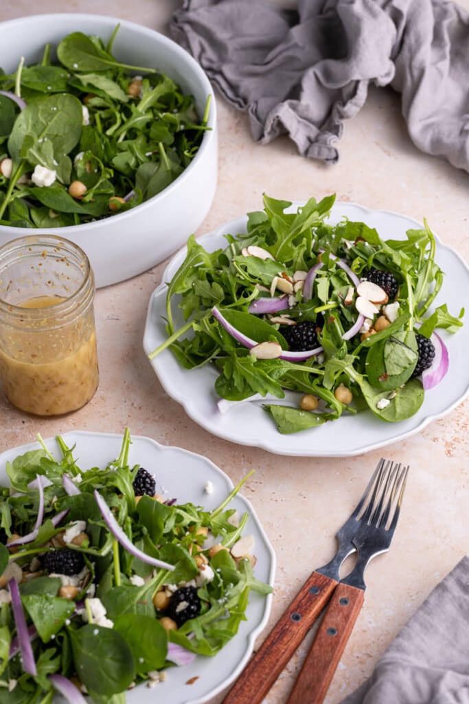 Spinach Arugula Salad with Honey Dijon Vinaigrette on salad plates
