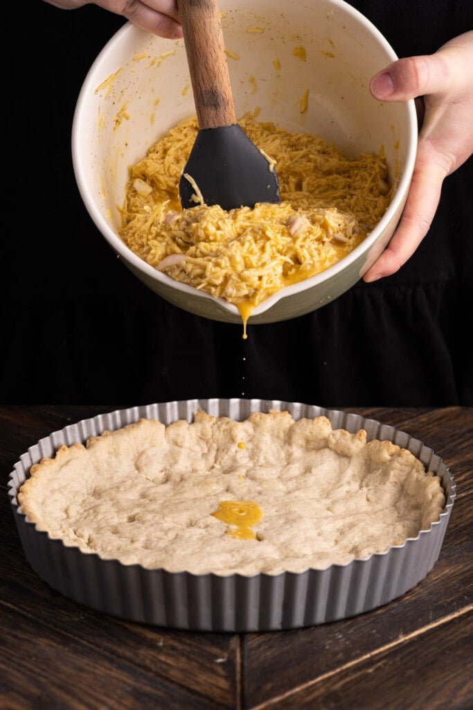 Adding quiche filling to baked crust