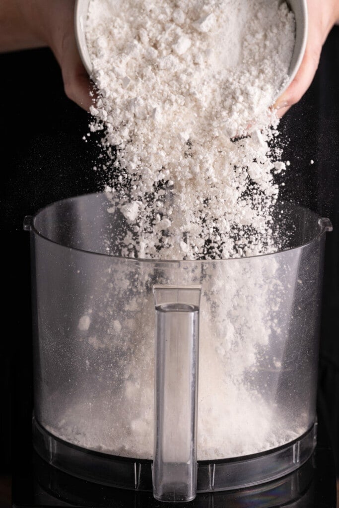 Adding flour to a blender to make quiche crust