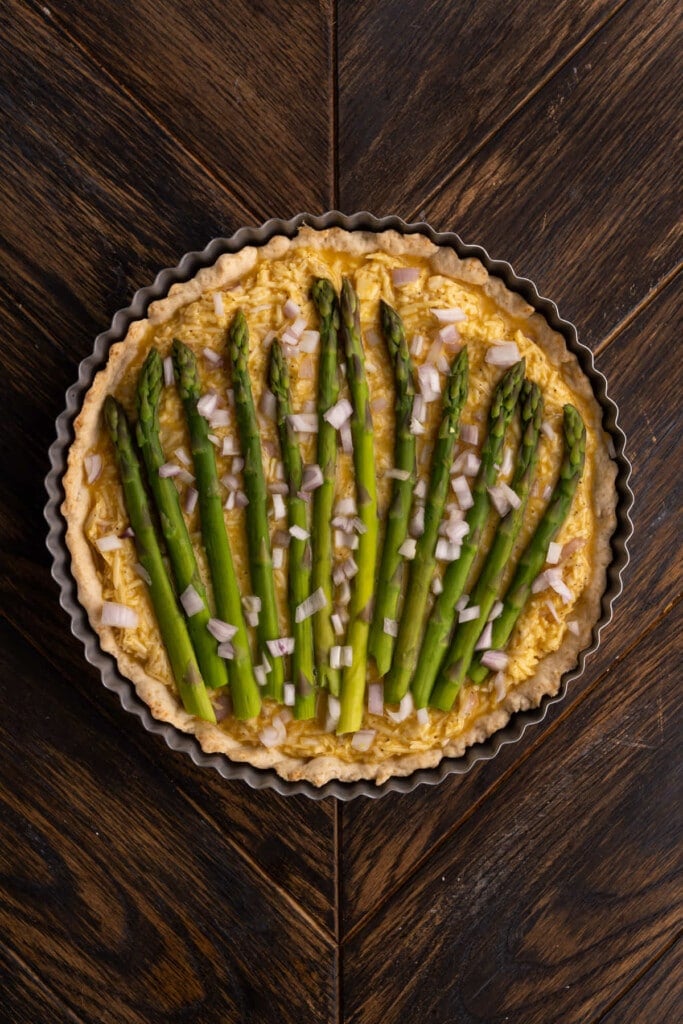 Assembling asparagus quiche to bake