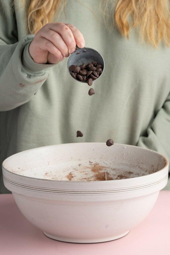 Adding chocolate chips to brownie batter