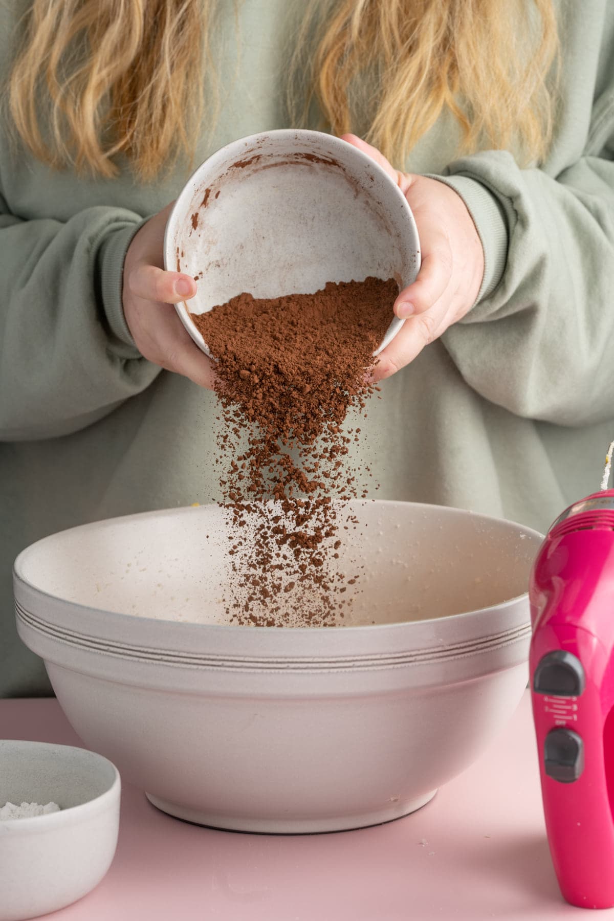 Adding cocoa powder to brownie batter