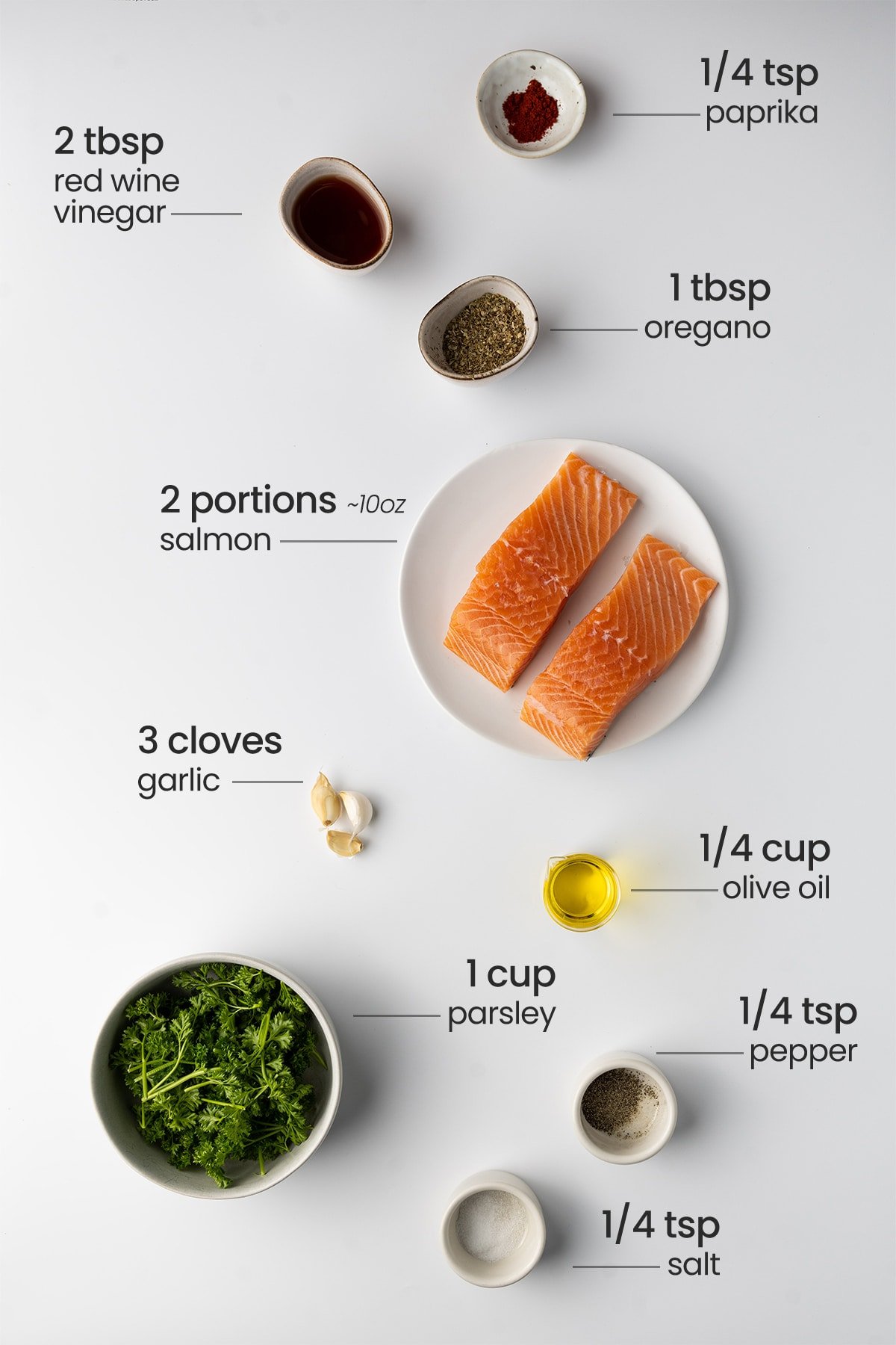ingredients for chimichurri salmon - red wine vinegar, paprika, oregano, salmon, garlic, olive oil, parsley, pepper, salt