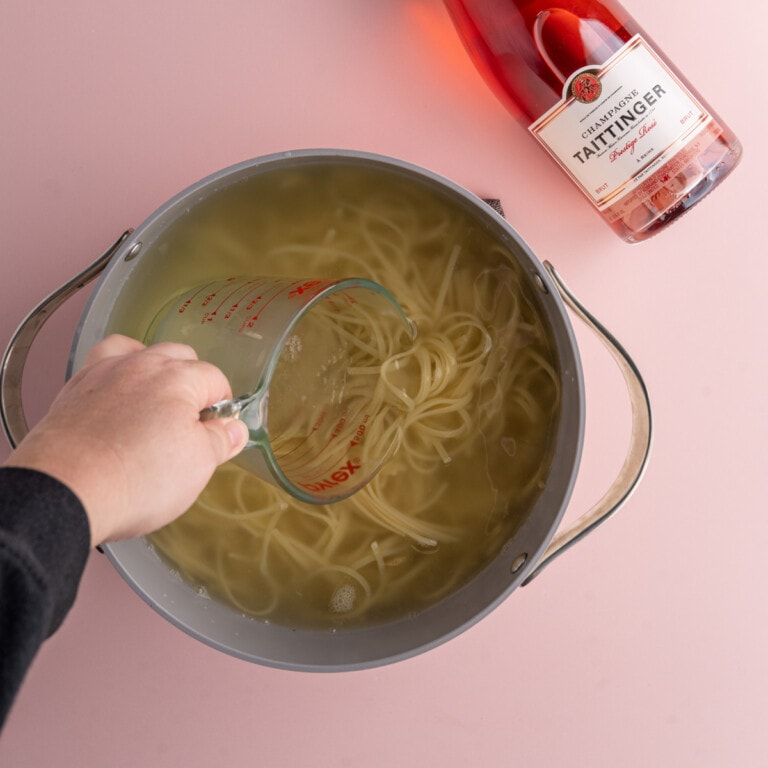 Conserving pasta water before straining cooked linguine