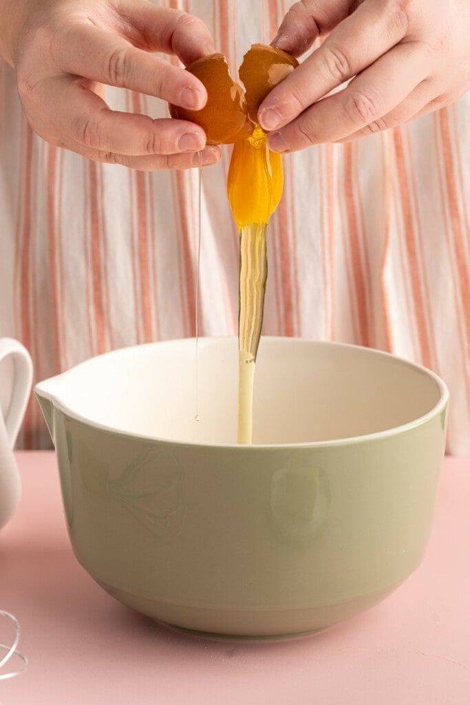 Cracking egg into pancake batter