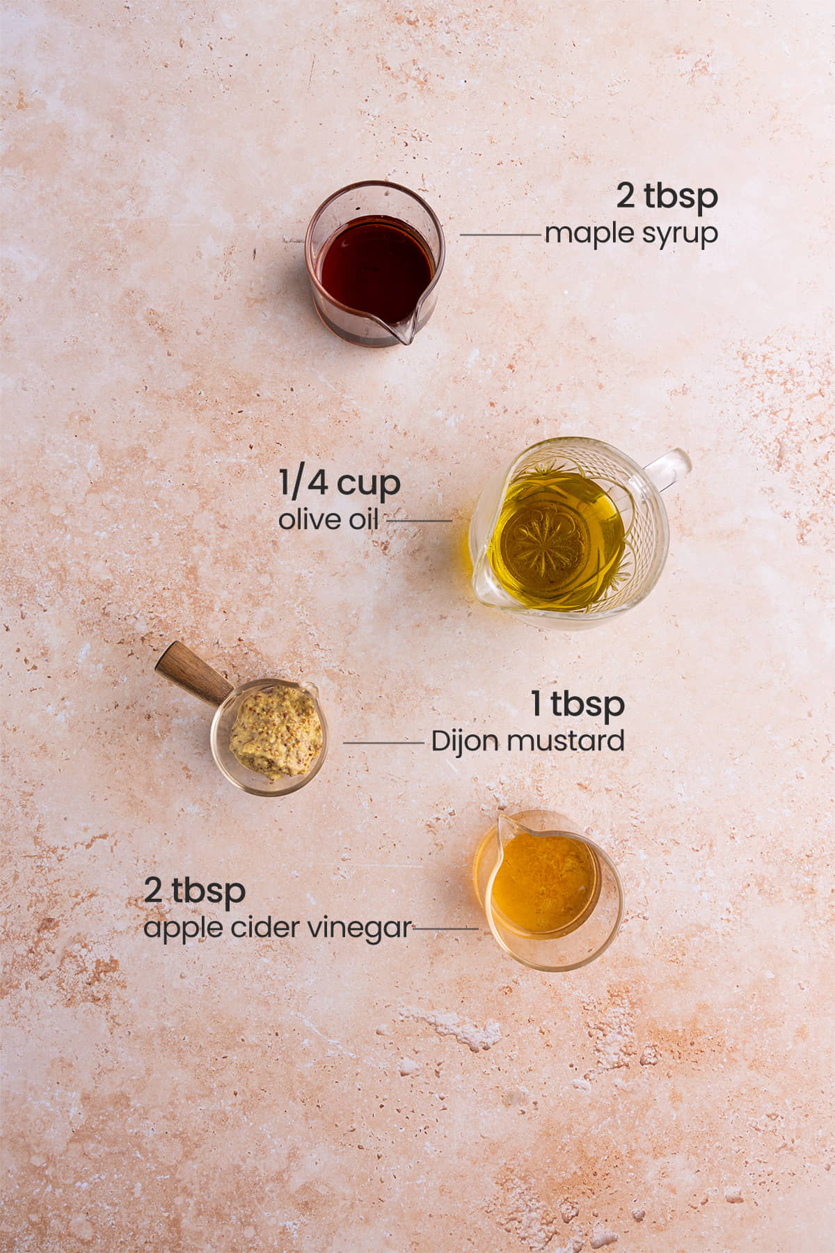 ingredients for maple Dijon vinaigrette - maple syrup, olive oil, Dijon mustard, apple cider vinegar