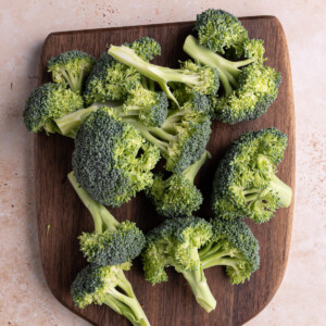 Broccoli ready for roasting on a cutting board