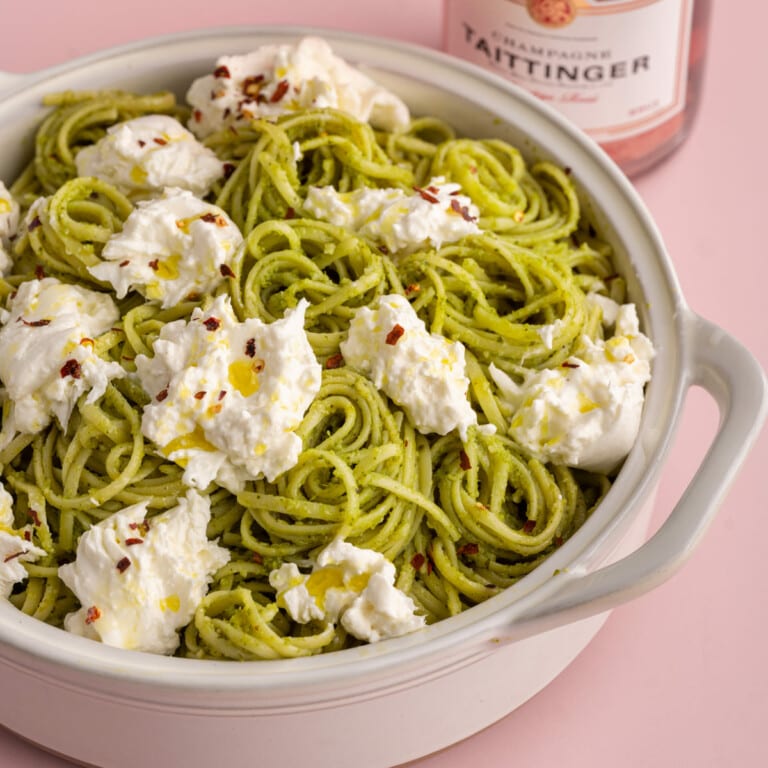 Linguine coated in pesto and topped with burrata, olive oil, and crushed red pepper
