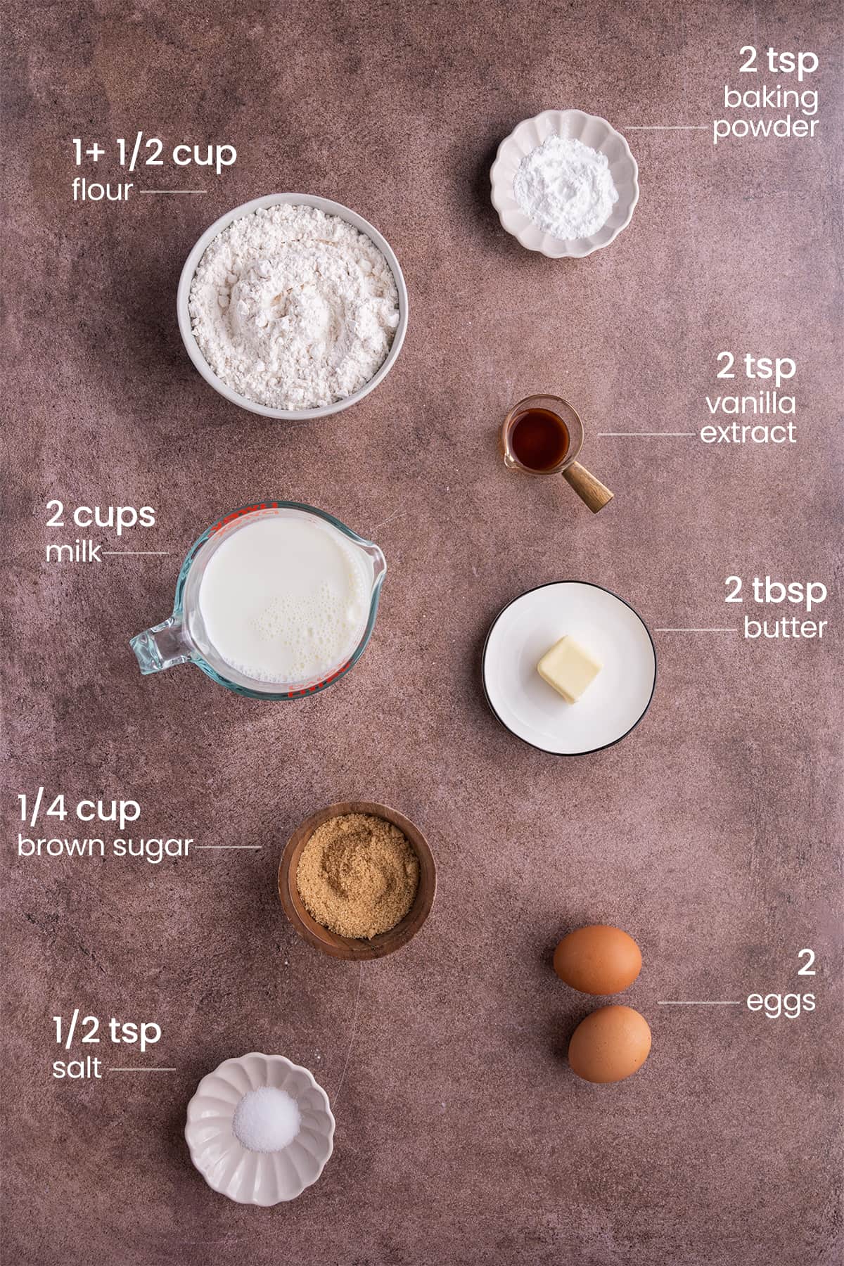 ingredients for sheet pan pancakes - baking powder, flour, vanilla extract, milk, butter, brown sugar, eggs, salt