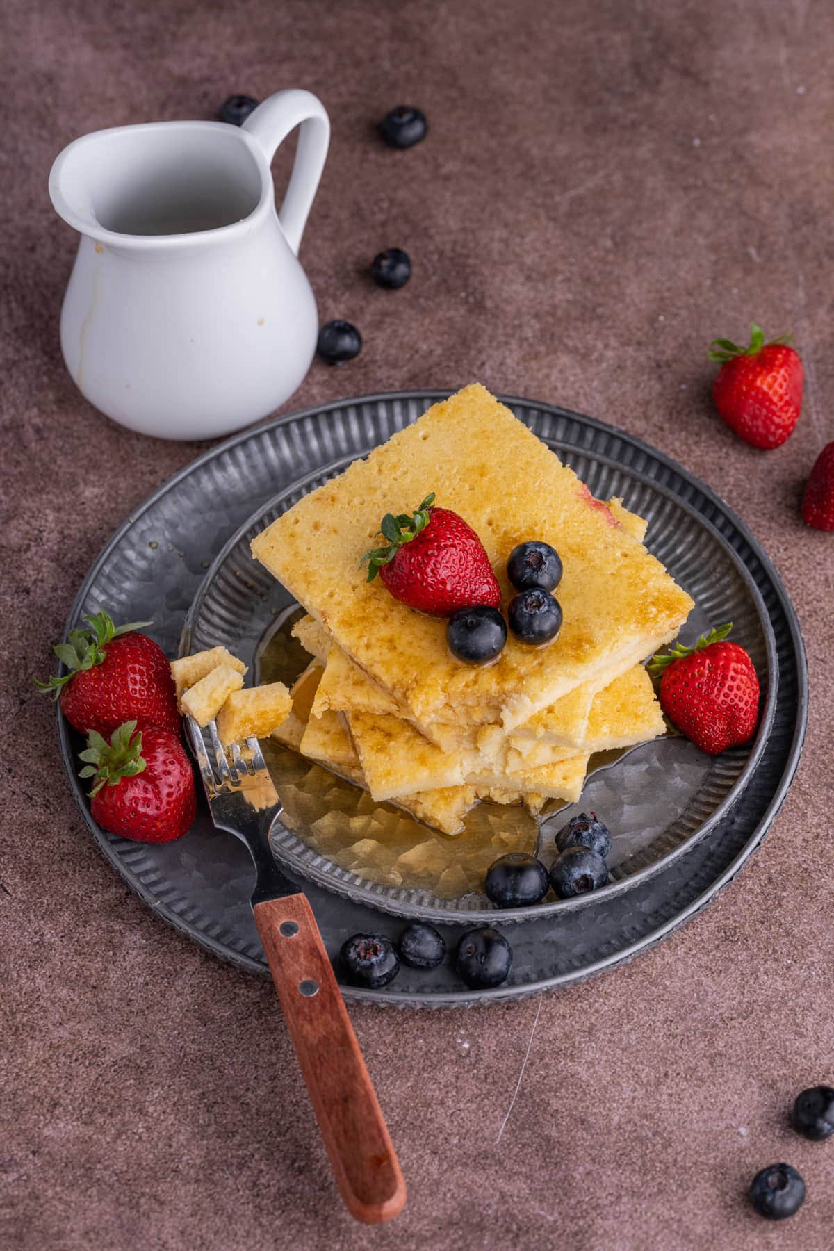 Stack of baked pancakes with bite on a fork