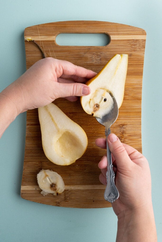 Scooping seeds out of pear