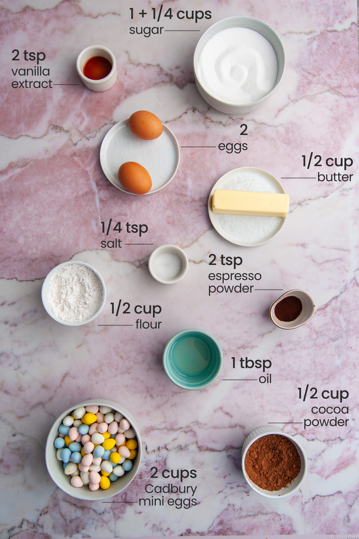 all ingredients for Cadbury Mini Egg Brownies - vanilla extract, sugar, eggs, butter, flour, salt, cadbury mini eggs, oil, cocoa powder, espresso powder