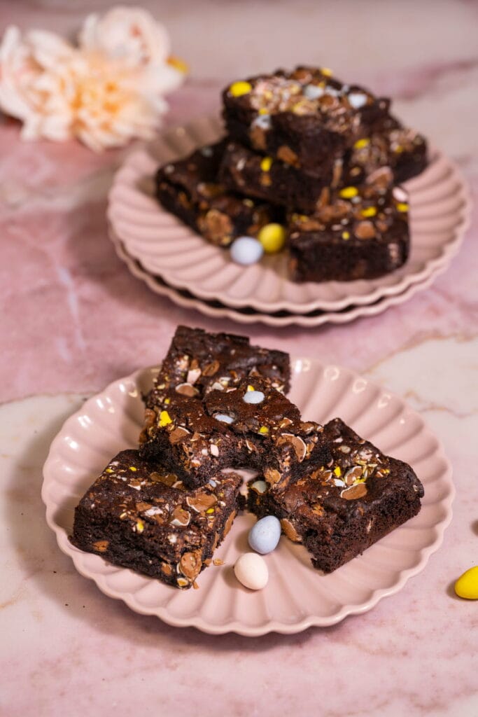 Cadbury Mini Egg Brownies on a Plate with a Bite Taken