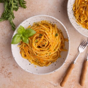 Bowl of Creamy Carrot Pasta garnished with basil