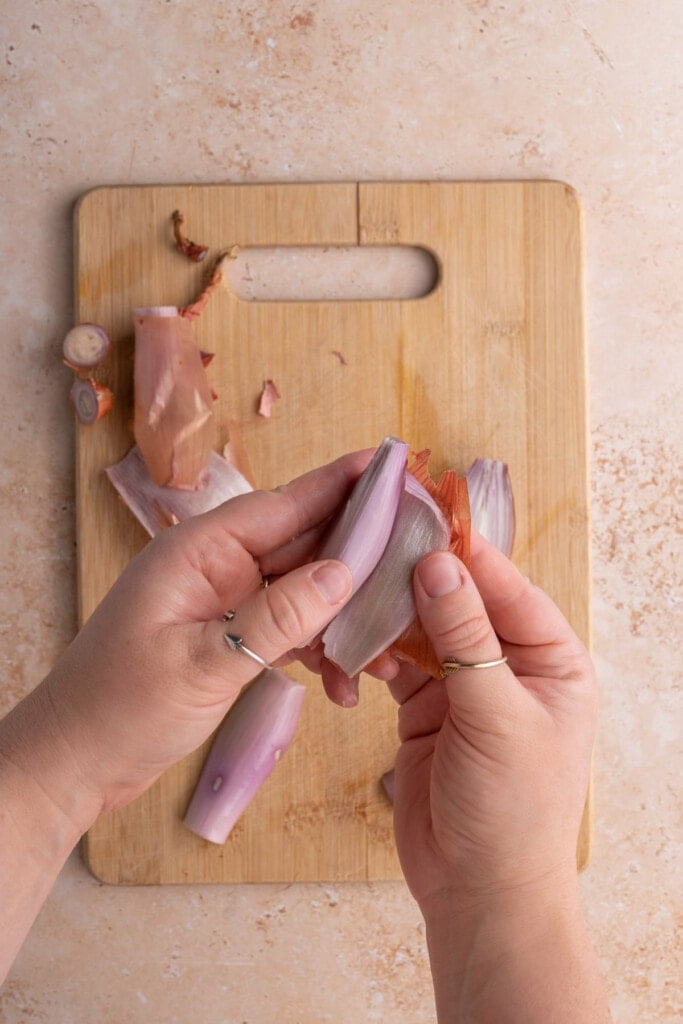 Peeling off outer layer of shallot