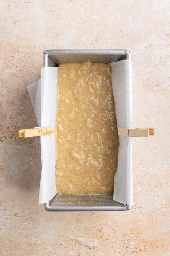 First layer of banana bread batter added to pan.