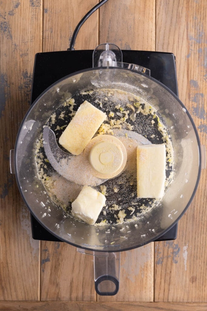 Adding butter and garlic salt to food processor