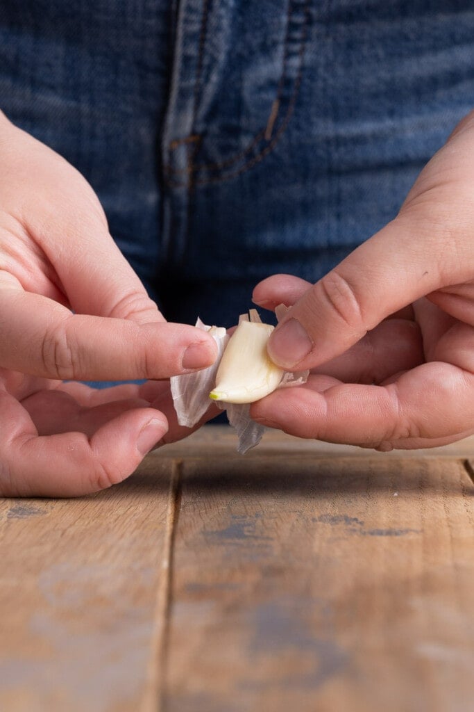 Peeling off outer layer of garlic