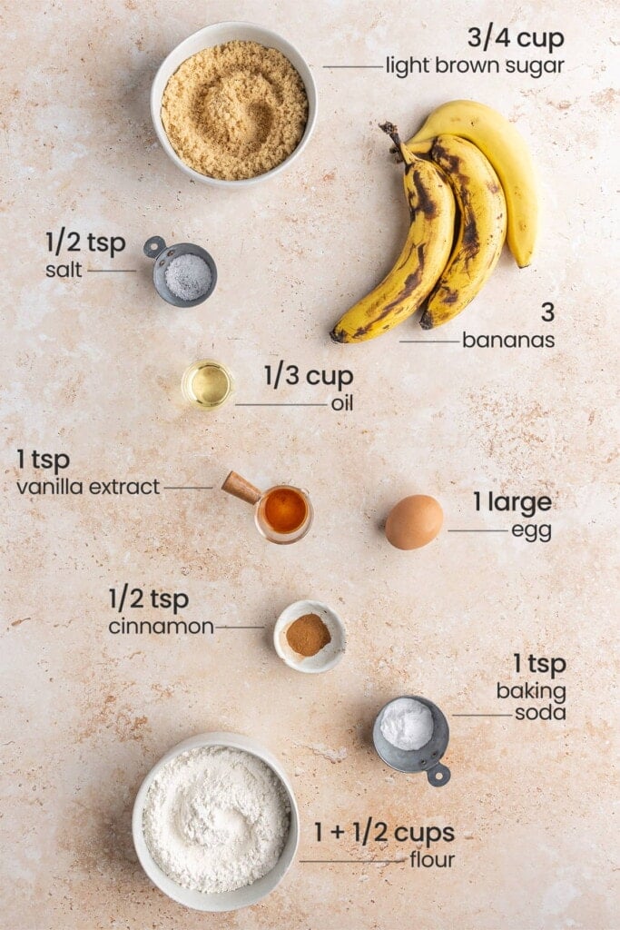 Ingredients for cream cheese banana bread - light brown sugar, salt, bananas, oil, vanilla extract, egg, cinnamon, baking soda, flour.