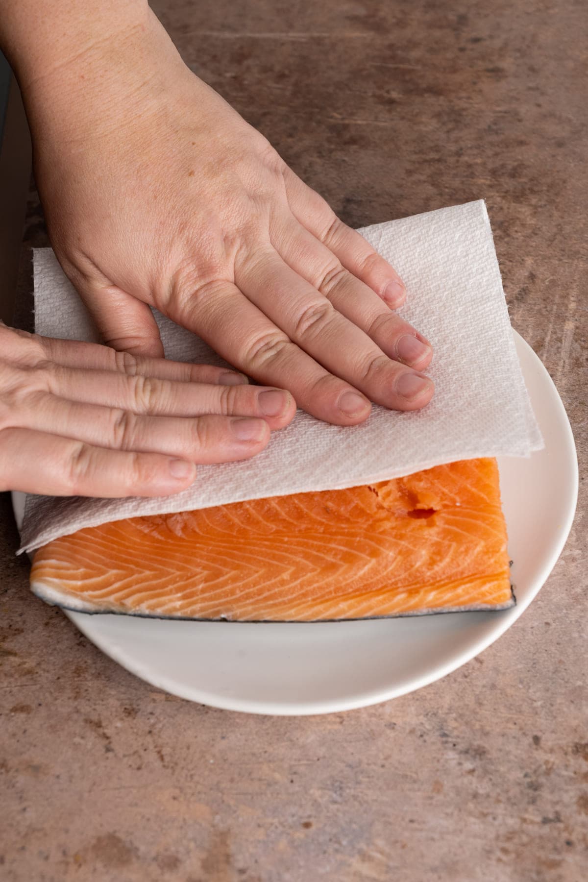 Patting salmon dry with a paper towel before adding Old Bay