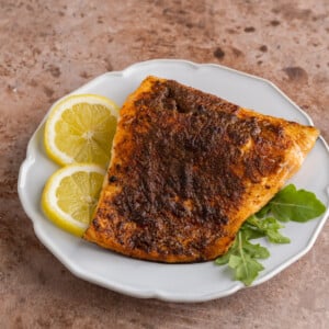 Old Bay Salmon on a plate with lemon slices