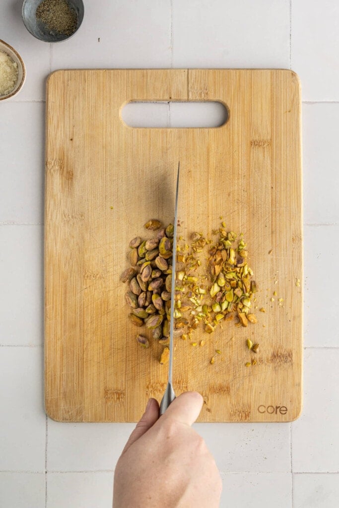 Chopping pistachios to make salmon crust.