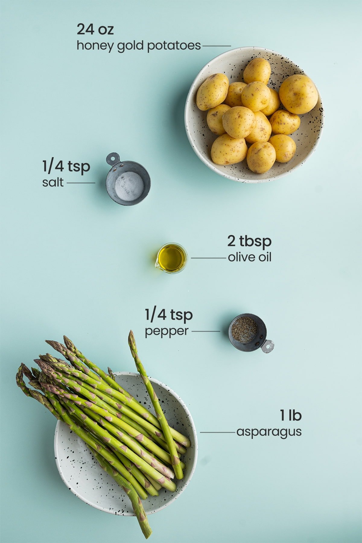 all ingredients for roasted potatoes and asparagus - honey gold potatoes, salt, olive oil, pepper, asparagus