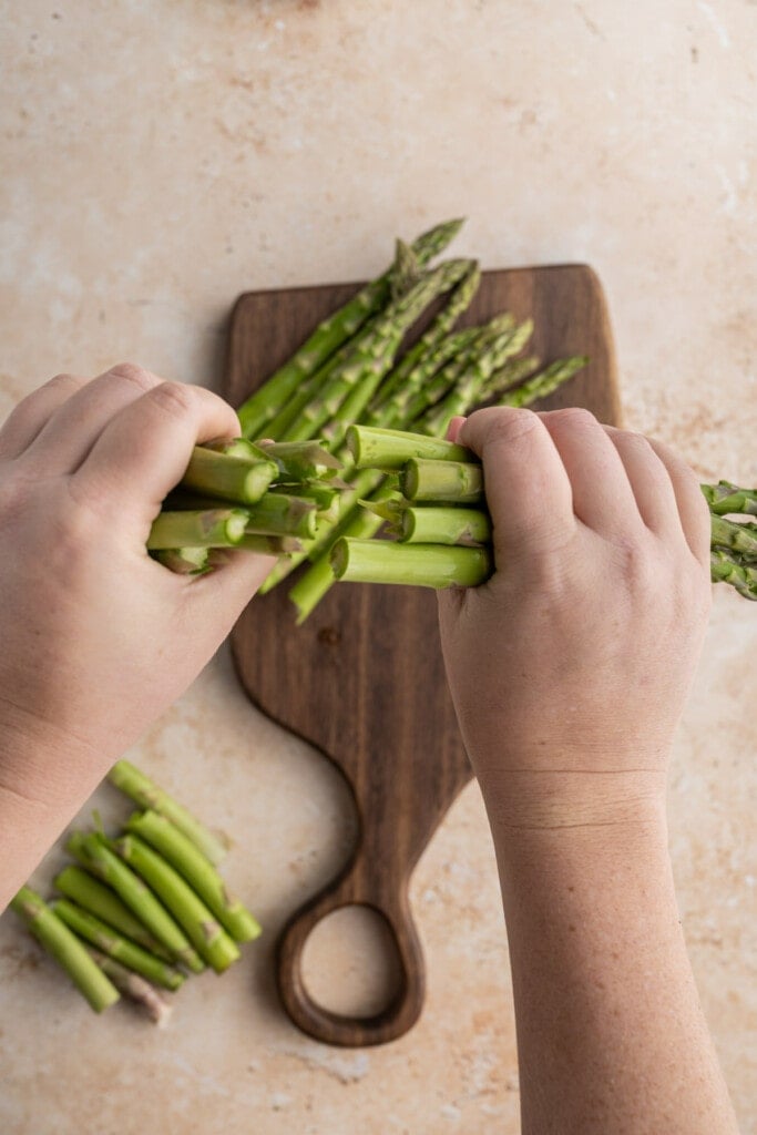 Breaking rough ends off asparagus for sheet pan salmon meal.