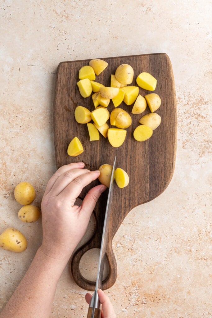 Slicing honey gold potatoes to roast with salmon and asparagus.